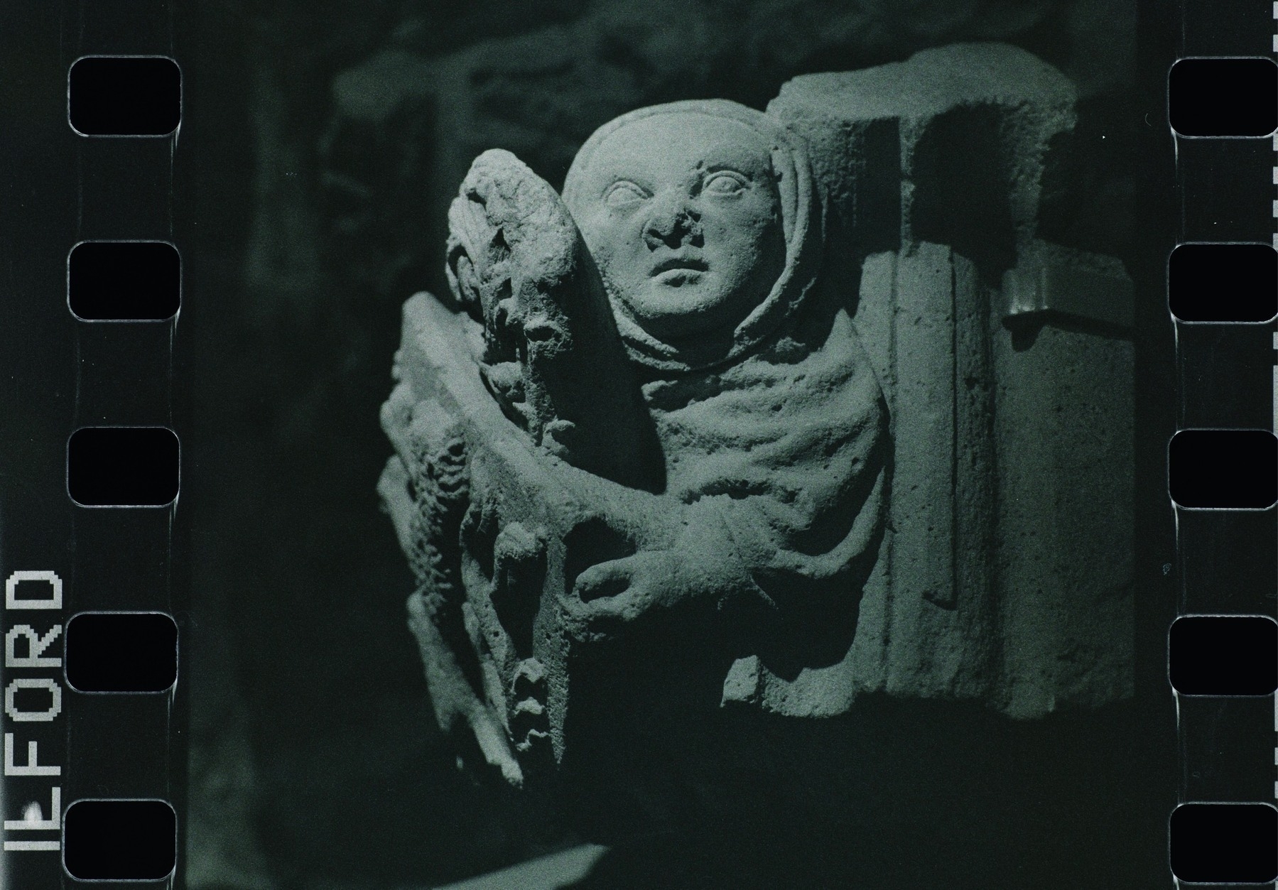 medieval sculpture of figure holding heraldic shield